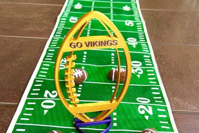 Custom 3D printed football centerpiece in team colors on a banquet table